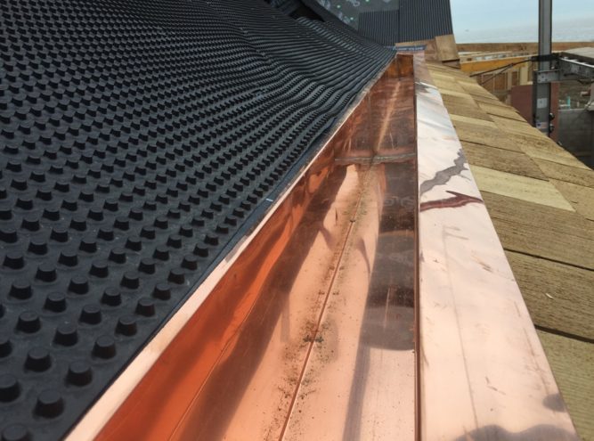 New copper gutter run on a shingle roof