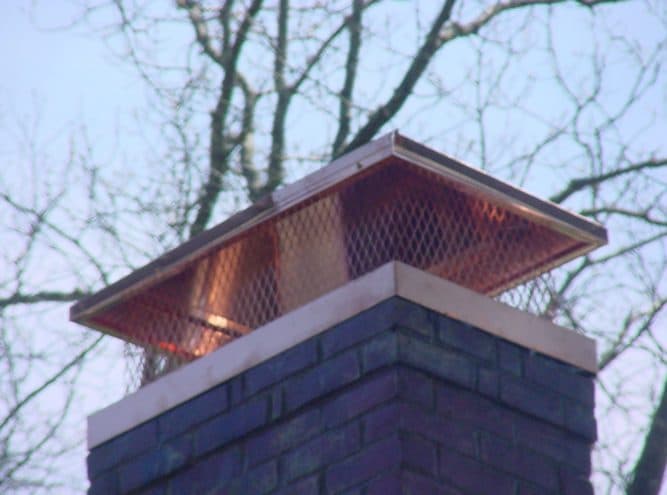 Chimney fitted with a custom copper cap